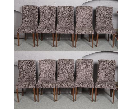 A set of 10 Carlick upholstered dining chairs with animal print and raised on square tapering supports.  