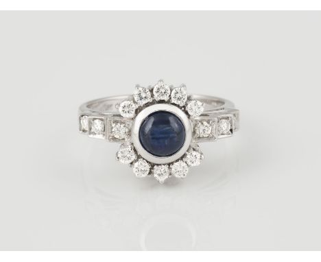RING Weißgold. Ringmaß ca. 53,5, Ges.-Gew. ca. 5,0 g. Geprüft 18 K. Ein Saphir-Cabochon, ca. 0,90 ct., 16 Diamanten, zus. ca.