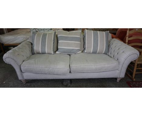 Chesterfield Upholstered Sofa, Would comfortably sit three people, with cushions, raised on turned feet, 77cm high, 238cm wid