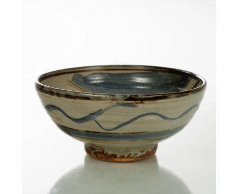 Michael Cardew (British 1901-1983), a stoneware bowl raised on a circular foot, blue and brown brush detailing to a cream gro