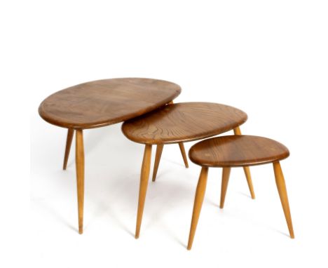 Ercol, a nest of three beech Pebble tables, on stylised triangular form on three turned tapering legs, the largest 66cm wide 