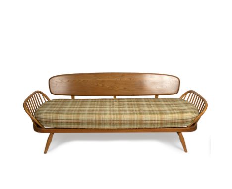 Ercol, a studio couch with solid panel back and slatted sides, bears Ercol sticker, one long seat cushion and three smaller c