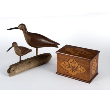 An inlaid wooden tea caddy, the hinged top and sides with floral motifs, 1925cm wide and a carved model of two curlew, one st