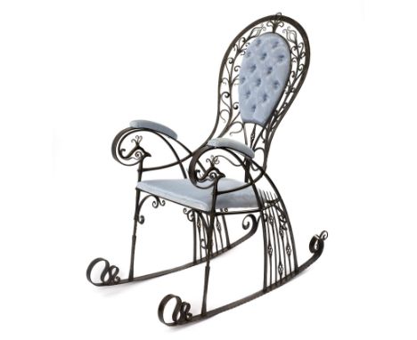 Derek Lloyd FWCB/The Peacock Chair/ a wrought iron rocking chair, the shaped back pierced with foliate stems and tendrils, th