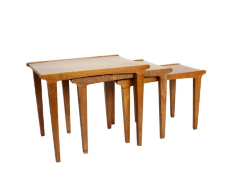 Gordon Russell, a mid 20th Century light oak nest of three tables, with raised crossgrain borders and tapering rectangular le
