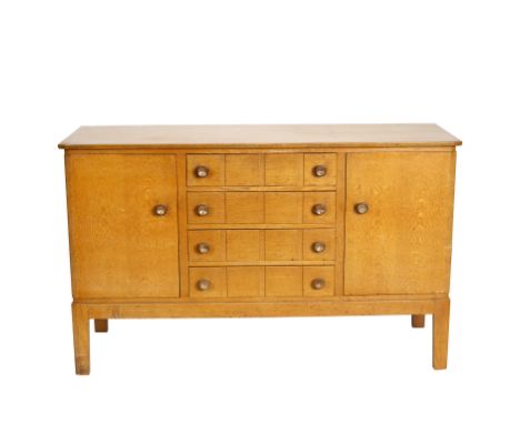 Gordon Russell, a mid 20th Century light oak sideboard, with cupboards flanking four drawers each with square panel decoratio