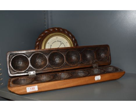 A carved wood ball holder or mould having carved decoration along with an Edwardian barometer