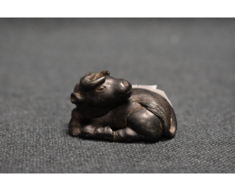 An early 20th century Japanese carved wood Netsuke sculpture of an Ox.
good condition overall.