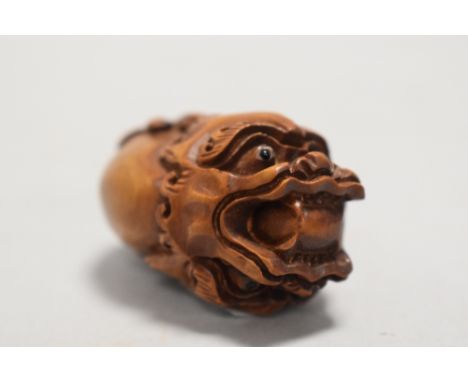 An early 20th century Japanese Netsuke carved as a double sided dragon