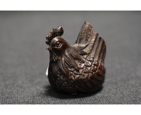 An early 20th century Japanese carved wood Netsuke of a Chicken or Hen