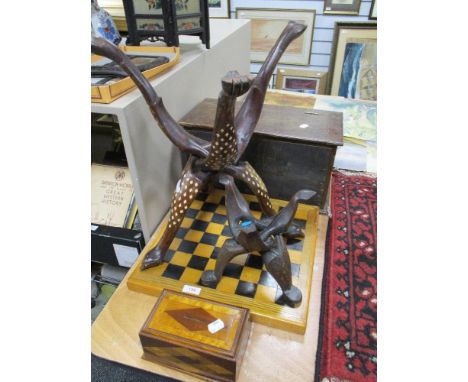 A selection of treen wood items including Indian table bases, chess board, money box and container