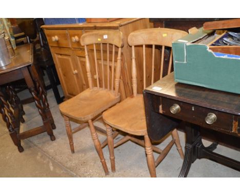 A pair of elm seated stick back kitchen chairs 