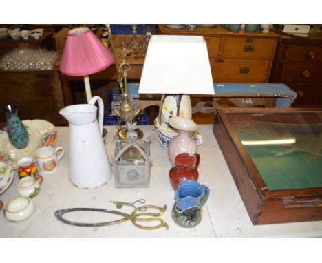 A white enamel jug; two Eastern brass oil lamps; a pottery table lamp and shade; a metal lantern etc. 