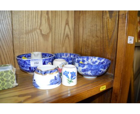 A Royal Worcester jug decorated with a goldfinch; two miniature tankards; a blue and white sugar bowl, cream jug; and two blu