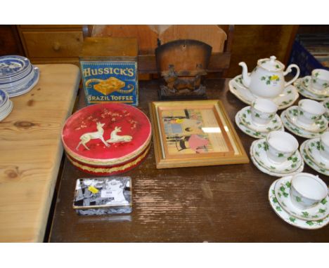 Two tins; a carved wooden letter rack; a porcelain trinket box and cover; and two pictures 