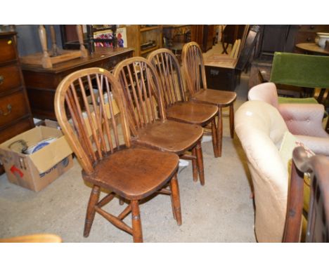 A set of four elm seated stick back kitchen chairs 