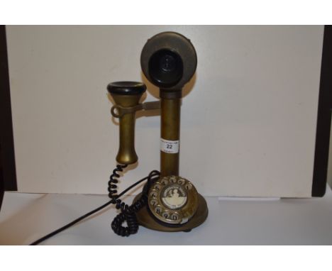 A brass candlestick telephone 