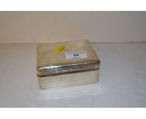 A silver engine turned decorated cigarette box