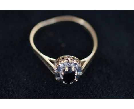 9ct Gold sapphire ring surround by white gem stones Size W