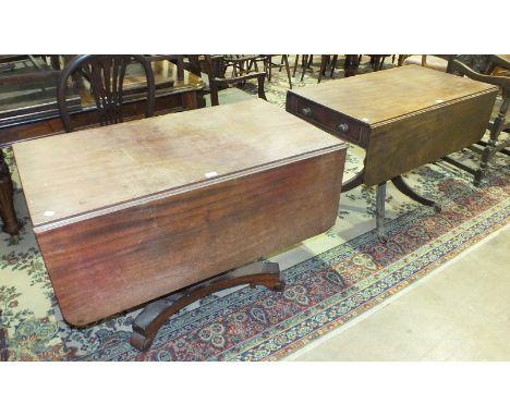 An early-19th century mahogany Pembroke table with end drawer, on turned column and reeded sabre legs with brass paw cappings