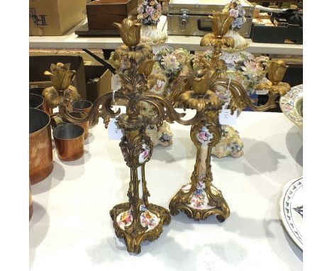 A pair of gilt-metal-mounted ceramic candelabra, one porcelain column broken, 42cm high.