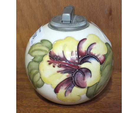 A Moorcroft ball-shaped cream-glazed table lighter decorated in the Hibiscus pattern, paper label to base, 11cm high.