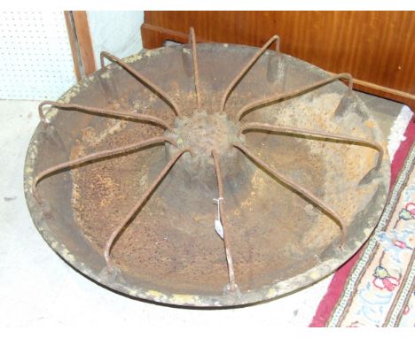 A cast iron 'Mexican Hat' pig feeding trough, 87cm diameter.