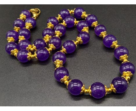 A Purple Jade Beaded Necklace with Gilded Spacers and Clasp. 44cm 