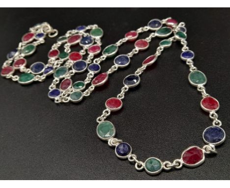 A 22 gram Ruby, Emerald and Sapphire Long Chain Necklace set in 925 Silver. 68cm. 