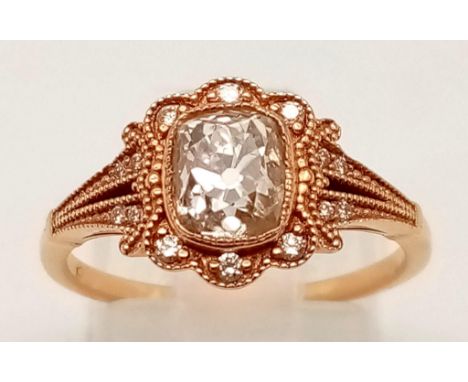 A VINTAGE STYLE 18K ROSE GOLD CUSHION CUT DIAMOND RING WITH LARGE CENTRE DIAMOND AND DIAMOND SURROUND.  3.7gms  size N\O 