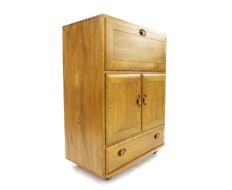Ercol light elm bureau, the fall-front enclosing a fitted interior over two cupboard doors and a single drawer, 32.5" wide, 4
