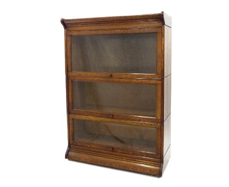 Globe Wernicke type oak three section bookcase with glazed rising fronts, 34" wide