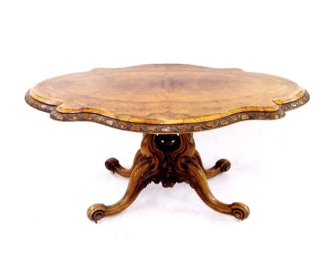 Attractive Victorian burr walnut loo table, with oval serpentine top, the rim with pokerwork scrolled leaf decoration upon an