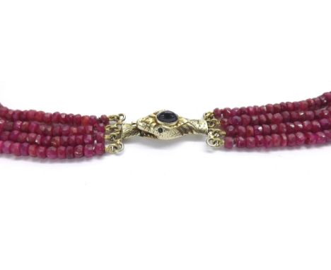 Four row ruby bead necklace, set with graduated faceted ruby beads to a 9ct gold snake head clasp, 22" long