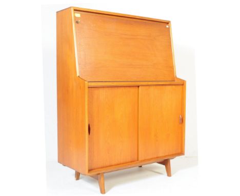 A retro vintage 1970 teak wood fall front writing desk, student bureau by Herbert Gibbs, having a fall front writing area ope