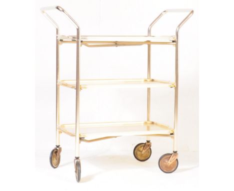A retro vintage mid 20th century circa 1950's butlers hostess serving cocktail trolley having a three tier of textured metal 