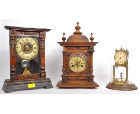 An assortment of three vintage 20th century mantle clocks. The lot to include a brass with glass domed,&nbsp; clock (crack to