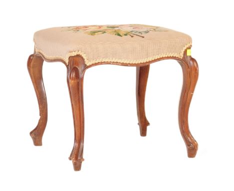 A 19th Century George III walnut dressing table stool. The stool having a floral patterned tapestry padded top raised and sup