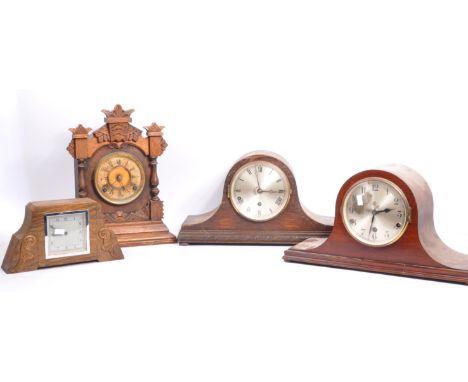 A collection of early 20th century clocks to include British mantel clock with scrolled carved details, a Gothic oak mantel c