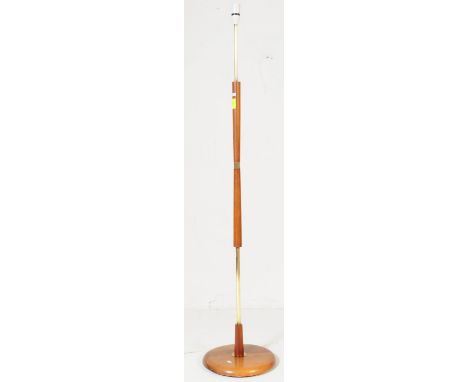 A retro vintage mid 20th century Danish inspired teak floor standing standard lamp having a turned shaped top over gilt tubul
