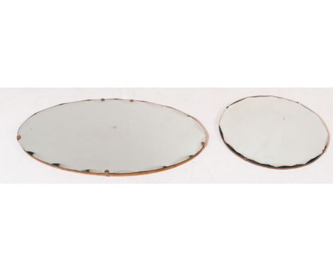 A retro vintage 20th century wall hanging mirror of circular form having bevelled edges. Together with another 20th century w