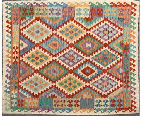 A 20th century Anatolian Turkish Kilim floor carpet rug. The rug having geometric lozenges in as variety of colours and a bor