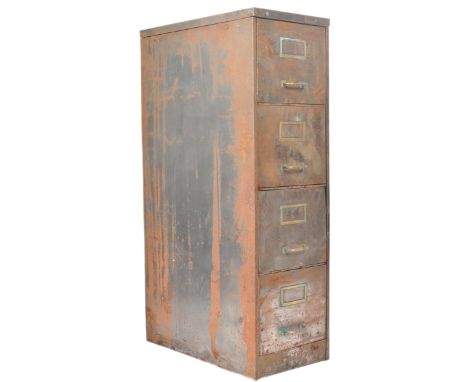 A vintage mid 20th Century Industrial upright pedestal filing cabinet having a bank of four drawers with brass handles and no