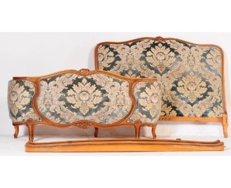 A 1930's French Louis XV style corbeille painted tapestry upholstered bow front double bed having show wood head and footboar