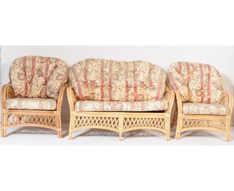 A retro vintage late 20th century bamboo wicker conservatory suite. Comprising of a two seater sofa settee with floral cushio