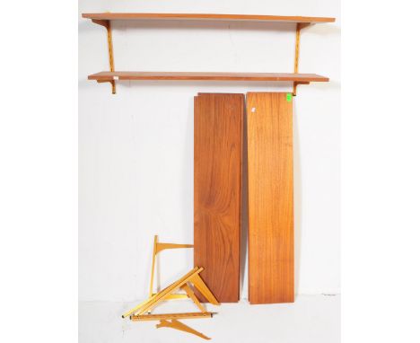 A set of retro vintage mid 20th century circa. 1970's teak wall shelves. Each being of rectangular with gilt metal brackets.