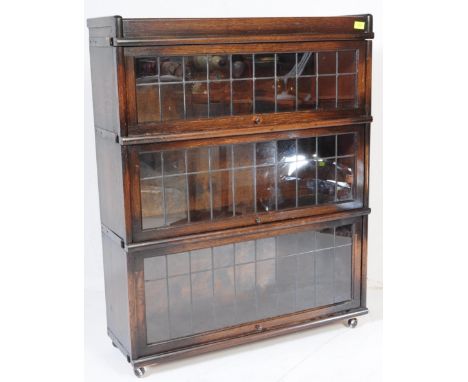 An early 20th century Edwardian circa. 1900's oak lawyers stacking bookcase having a stack of leaded glass fall front shelves