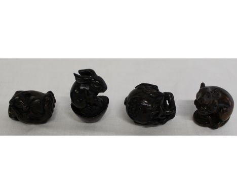 4 Japanese hardwood signed netsuke: - rat, rabbit, ox and fruit, all with signed mother of pearl circular panels