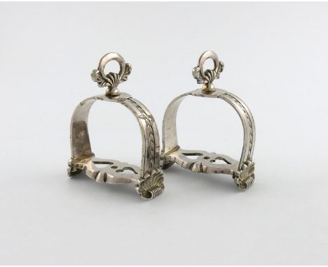 A pair of South American stirrups, unmarked, twentieth century, conventional form, oval ring attachment, foliate decoration, 