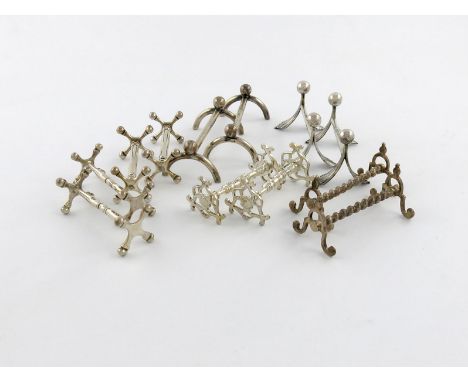 A small collection of silver knife rests, comprising: a pair of Edwardian Albany pattern knife rests, by Henry Wilkinson Limi